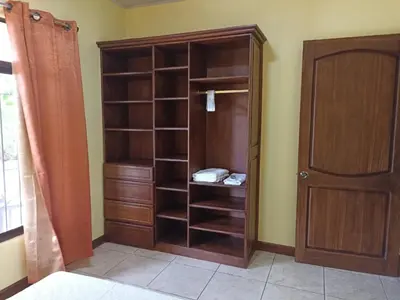 a closet with wooden shelves in a room at Villa Ceiba in Fortuna