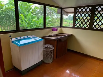 a bathroom with a sink and a window at Villa Ceiba in Fortuna