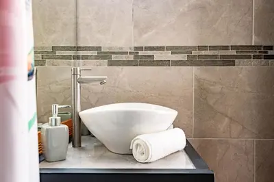 a bathroom with a sink and a toilet on a counter at Shark Town Mal Pais in Santa Teresa Beach