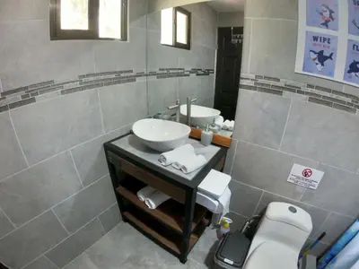 a bathroom with a sink and a mirror at Shark Town Mal Pais in Santa Teresa Beach