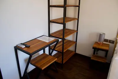 a room with a book shelf and a desk at Shark Town Mal Pais in Santa Teresa Beach