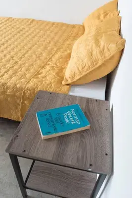 a book sitting on a table next to a bed at NAPPO Room 2 Alajuela, Heredia,SJO,5min from airport NO PARKING in Guácima