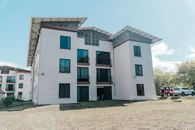 a large white building with a lot of windows at Apartamento Ganesha Liberia in Santa Ana