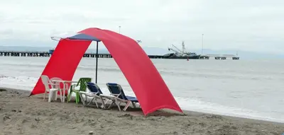 a group of chairs and umbrellas on the beach at Hotel Aldea Chorotega Puntarenas in Puntarenas