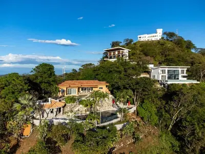 an aerial view of a house on a hill at Stunning Mountaintop Property with Stylish Main Home, Private Guesthouse & Infinity Pool in Santa Cruz
