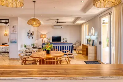 a living room with a table and chairs at Stunning Mountaintop Property with Stylish Main Home, Private Guesthouse & Infinity Pool in Santa Cruz