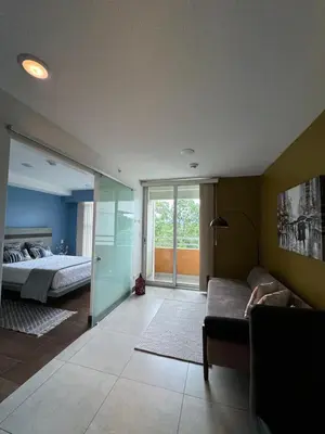 a living room with a bed and a couch at Lovely Apartment near Costa Rica airport in Heredia