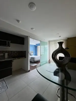 a room with a glass table with a vase on it at Lovely Apartment near Costa Rica airport in Heredia