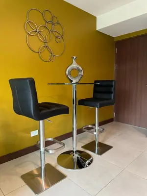 two black chairs and a glass table in a room at Lovely Apartment near Costa Rica airport in Heredia