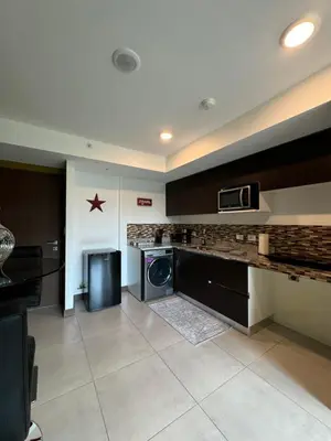 a kitchen with a washer and dryer in a room at Lovely Apartment near Costa Rica airport in Heredia