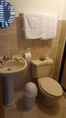 a bathroom with a toilet and a sink at Oceanview 6th Floor Jaco Condo in Jacó