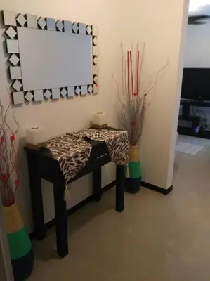 a room with a table and a mirror and vases at Oceanview 6th Floor Jaco Condo in Jacó