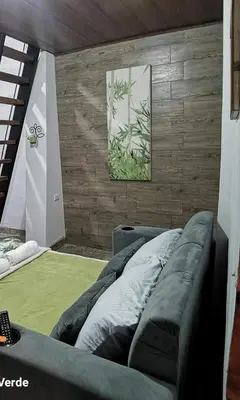 a room with a couch and a picture on the wall at Cabaña Bambú in Cartago