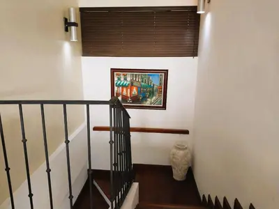 a stairway with a painting on the wall at Presidential Suites 4 - Spacious condo in the heart of Flamingo, sleeps 6 in Playa Flamingo