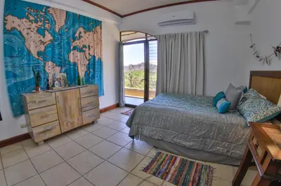 a bedroom with a bed and a large window at Presidential Suites 4 - Spacious condo in the heart of Flamingo, sleeps 6 in Playa Flamingo
