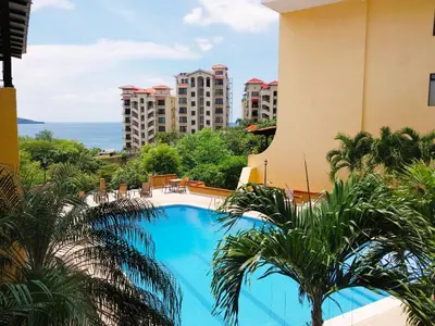 a view from the balcony of a hotel with a swimming pool at Presidential Suites 4 - Spacious condo in the heart of Flamingo, sleeps 6 in Playa Flamingo