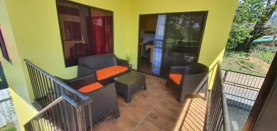 a balcony with two chairs and a table at Tío King Hospedaje Turístico in Uvita