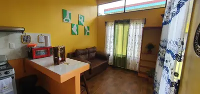 a living room with a couch and a table at Tío King Hospedaje Turístico in Uvita