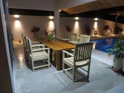 a dining room with a wooden table and chairs at New Hill top Home with a Beautiful Tropical View in Esperanza