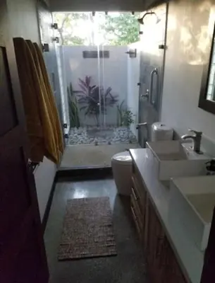 a bathroom with a sink and a toilet and a shower at New Hill top Home with a Beautiful Tropical View in Esperanza