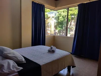 a bedroom with a bed with a stuffed animal on it at Hotel Alajuela Costa Rica Airport in Alajuela City