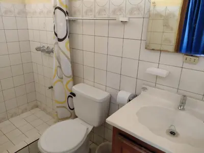 a bathroom with a toilet and a sink at Hotel Alajuela Costa Rica Airport in Alajuela City