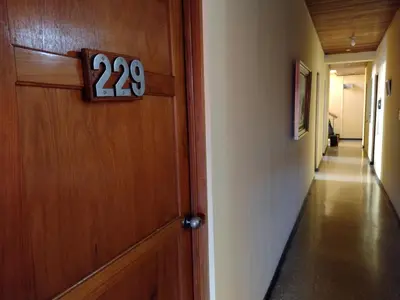 a door with a number on it next to a hallway at Hotel Alajuela Costa Rica Airport in Alajuela City