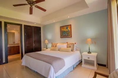 a bedroom with a bed and a ceiling fan at Adults Only 4BR Penthouse w Partial Ocean View, Carao Reserva Conchal in Playa Conchal