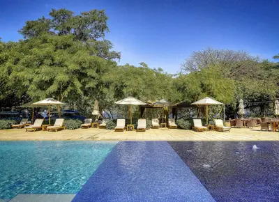 a swimming pool with lounge chairs and umbrellas next to at Adults Only 4BR Penthouse w Partial Ocean View, Carao Reserva Conchal in Playa Conchal