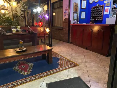 a room with a bench and a table in a store at Hotel Amón Real Costa Rica in San José