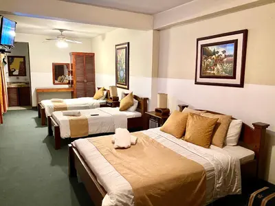 a hotel room with three beds in a room at Hotel Amón Real Costa Rica in San José