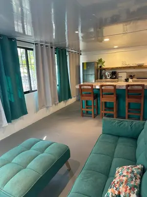 a living room with a couch and a kitchen at Beach Front Bahia in Sámara