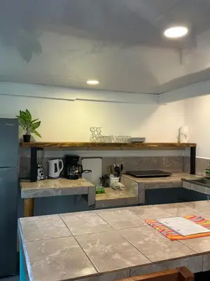 a kitchen with a counter top in a room at Beach Front Bahia in Sámara