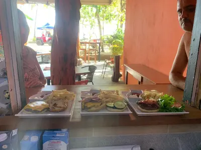 a table with two plates of food on it at Beach Front Bahia in Sámara