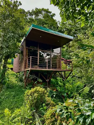 a small building in the middle of a field at Hotel de Montaña El Pelicano in San Isidro