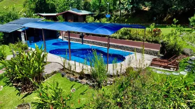 an overhead view of a swimming pool with a blue cover at Hotel de Montaña El Pelicano in San Isidro
