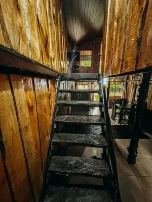 a set of wooden stairs in a cabin at Cabaña Piqueza! in Poás