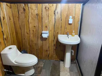 a bathroom with a toilet and a sink at Cabaña Piqueza! in Poás
