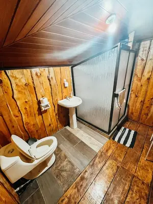 a bathroom with a toilet and a sink at Cabaña Piqueza! in Poás