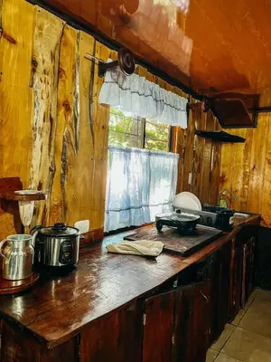 a kitchen counter with pots and pans on it at Cabaña Piqueza! in Poás