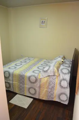 a bedroom with a bed with a quilt on the floor at #3 Private room Close to Airport in Alajuela City
