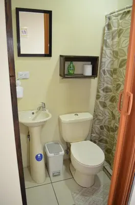a bathroom with a toilet and a sink at #3 Private room Close to Airport in Alajuela City
