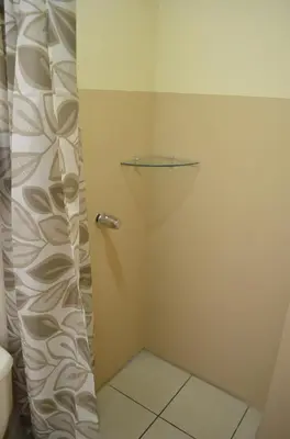a shower with a glass door in a bathroom at #3 Private room Close to Airport in Alajuela City