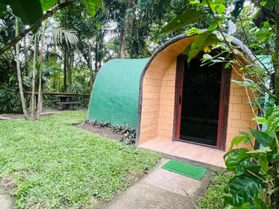 a small building with a green roof in a yard at The Wellness Park Costa Rica in Fortuna