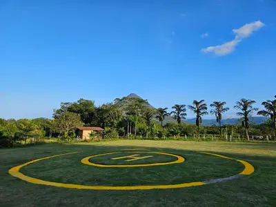 a basketball court on a grass field with a basketball hoop at The Wellness Park Costa Rica in Fortuna