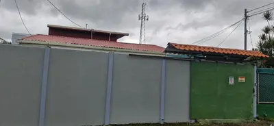 a building with a fence next to a building at La casa del volcán in Fortuna