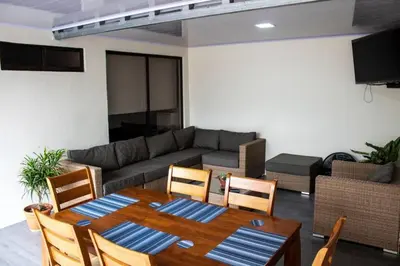 a living room with a table and a couch at La casa del volcán in Fortuna