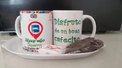 two coffee mugs on a plate on a table at Sleep&Go! Cabina Familiar con 5 camas - Siquirres centro in Siquirres