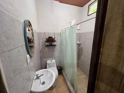 a bathroom with a sink and a toilet and a shower at Natural Experience House in Tortuguero