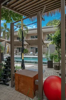 a view of a house with a swimming pool at Tamarindo Bay Boutique Hotel, Apartments & Suites in Tamarindo
